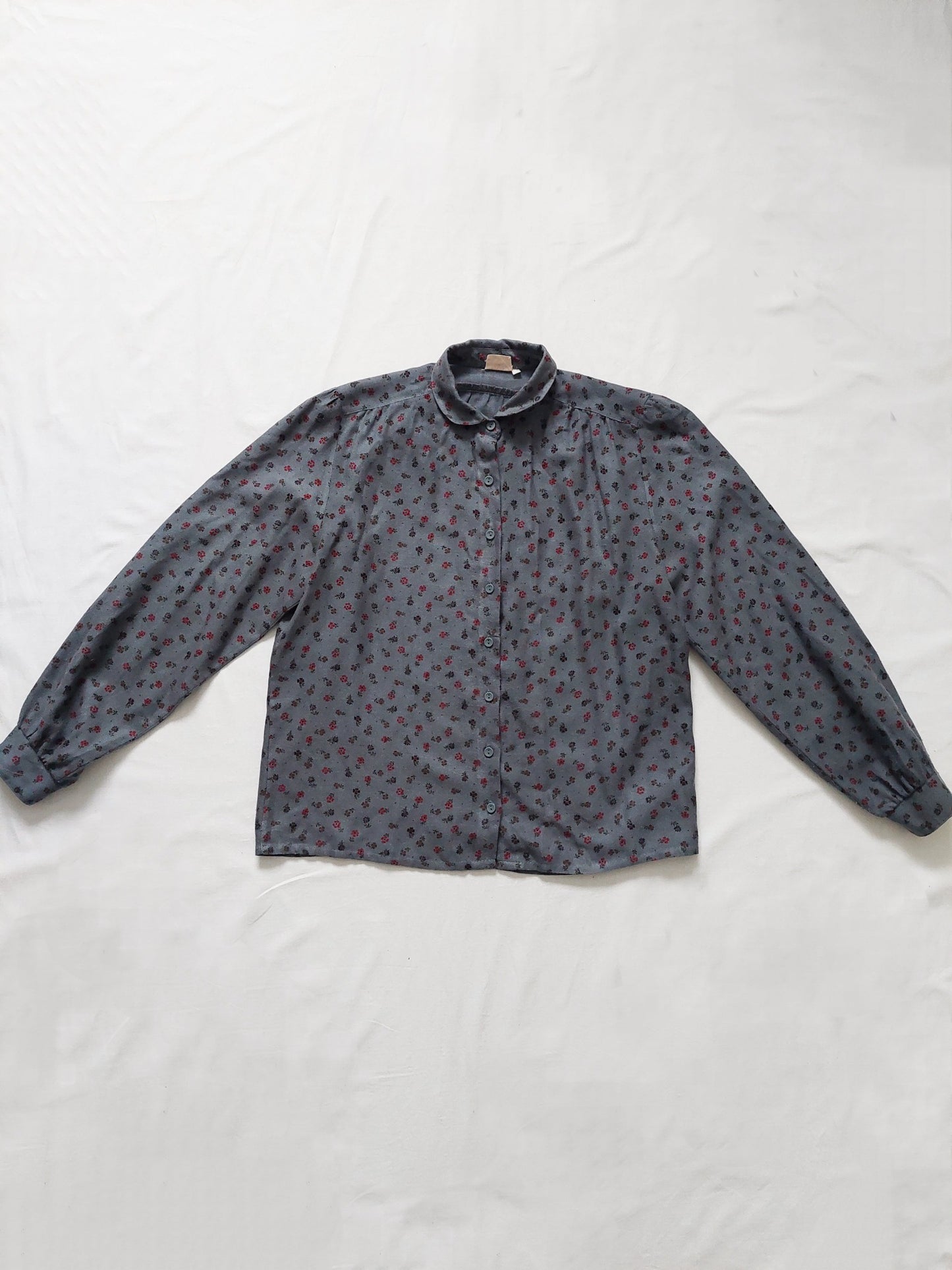 A blue shirt with small flower details