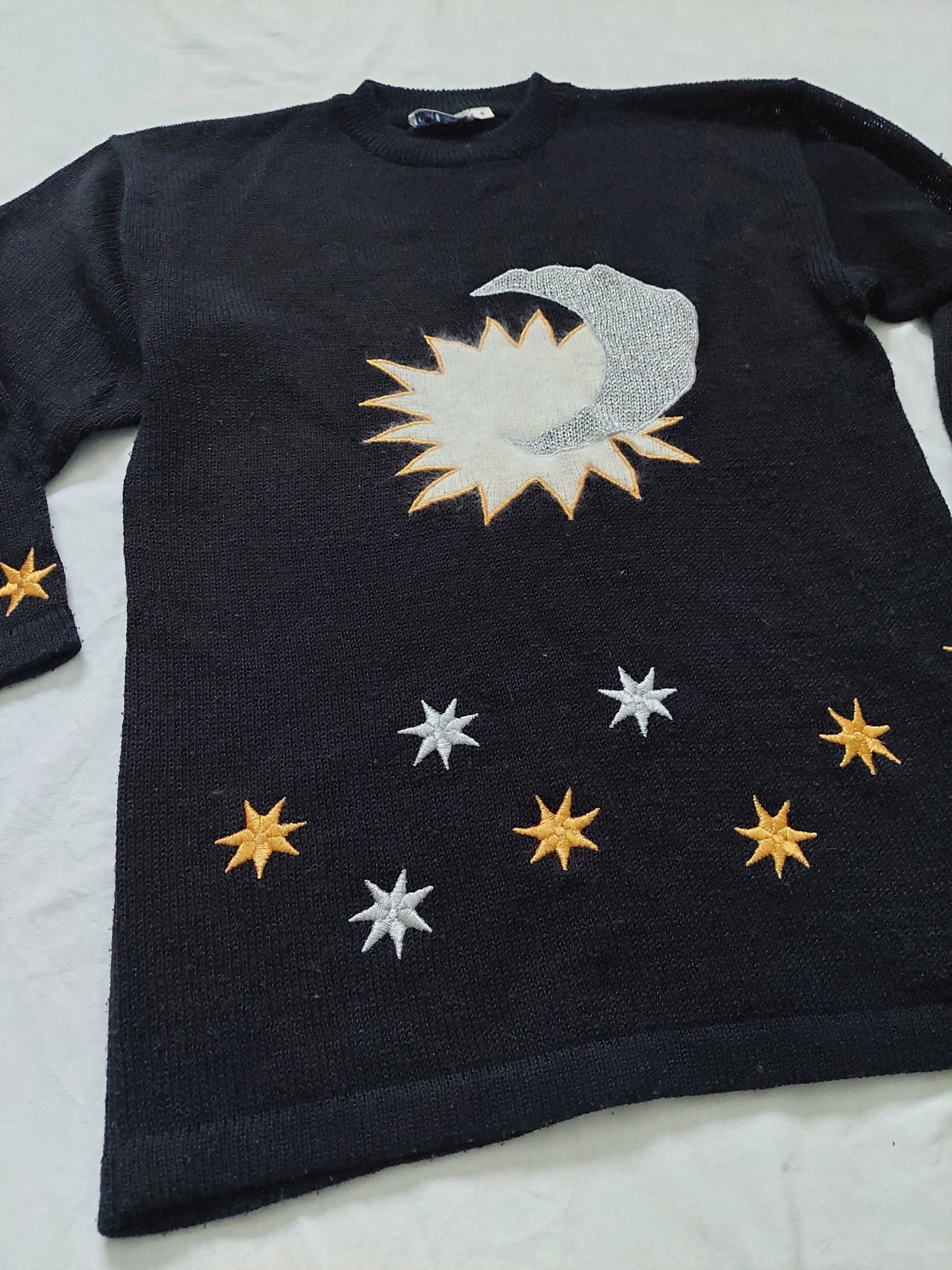 A close up of the black star sweater