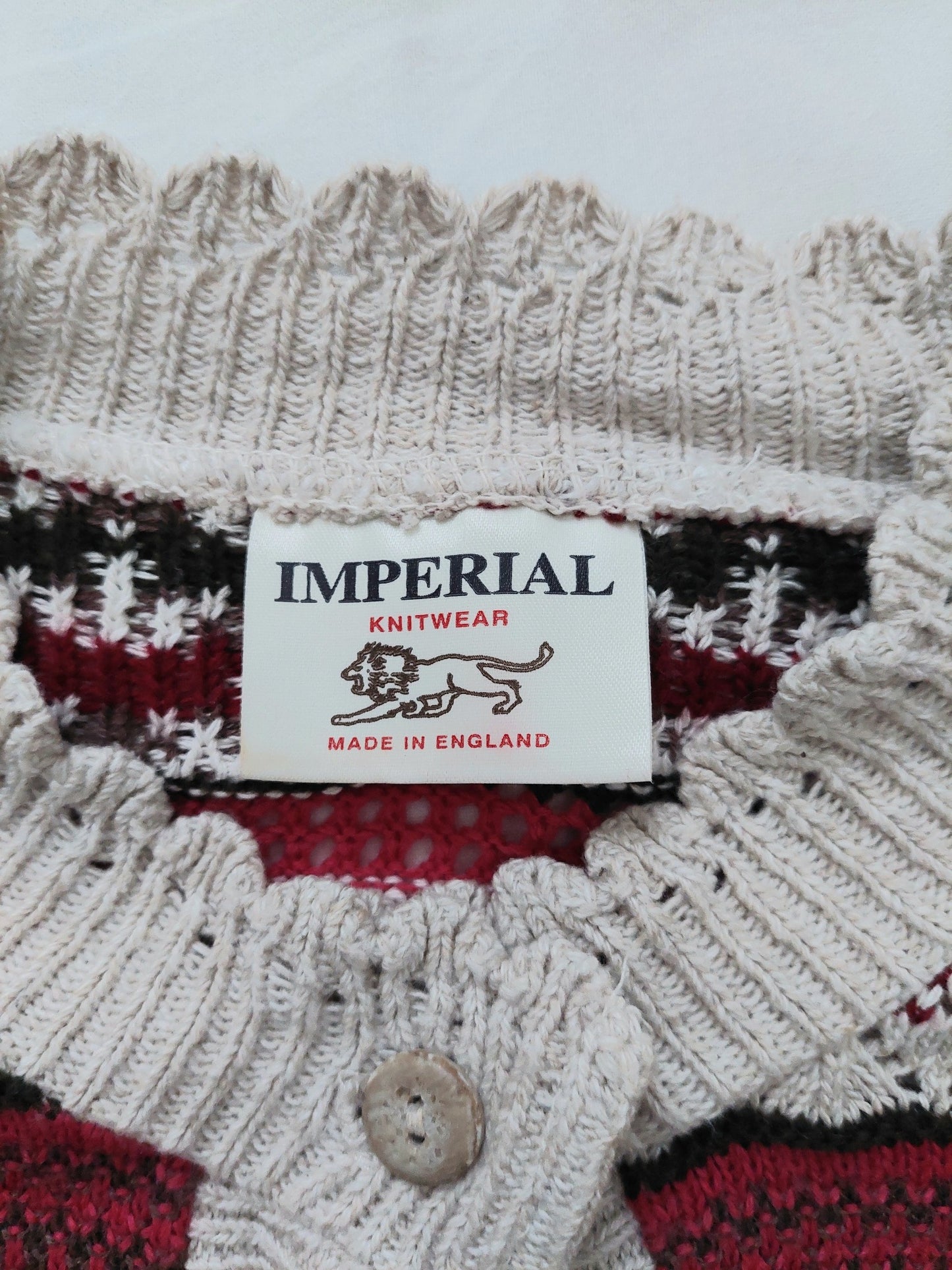 A picture of the tag of the multicoloured knitted cardigan