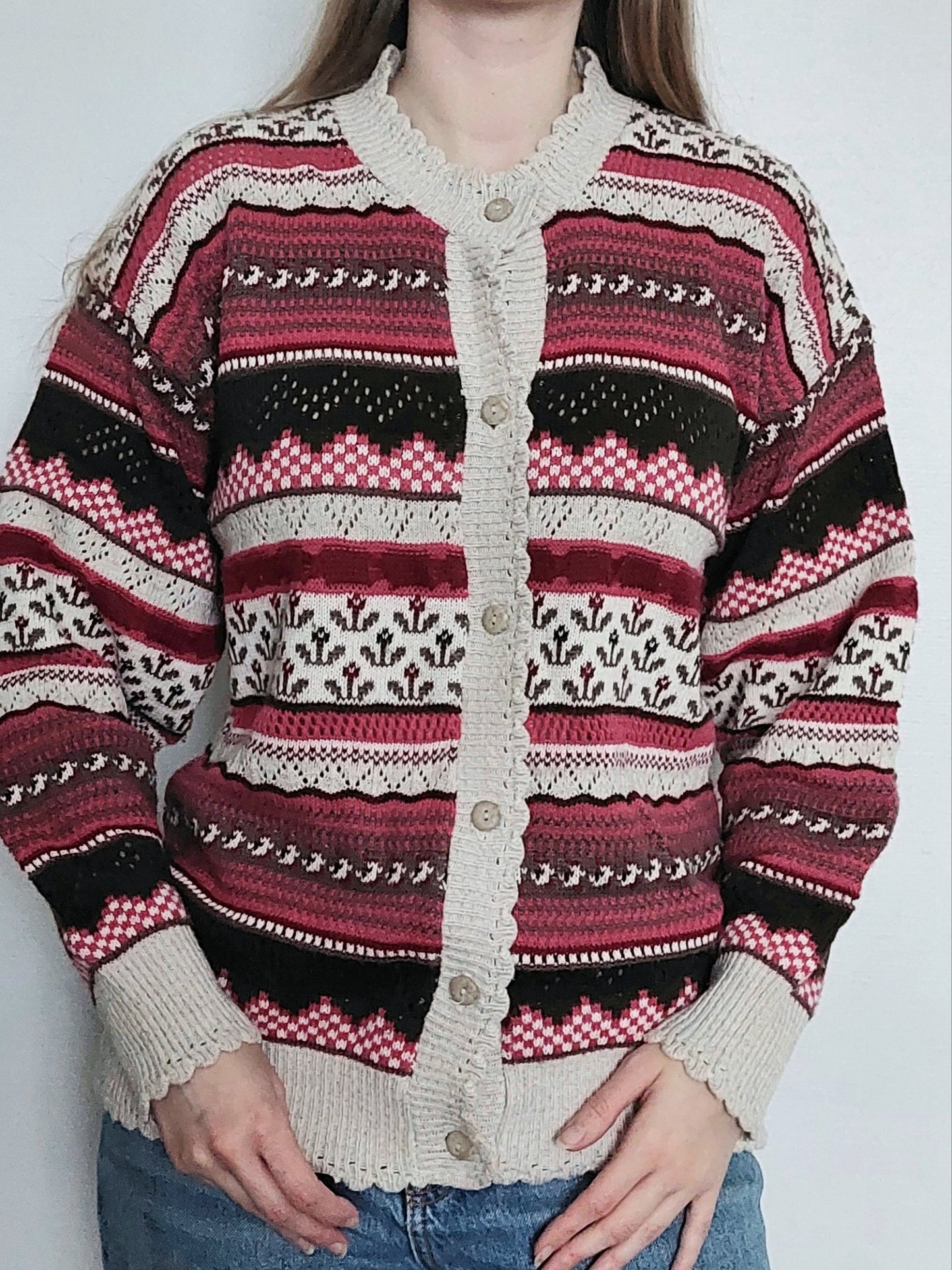 A person wearing the multicoloured knitted cardigan