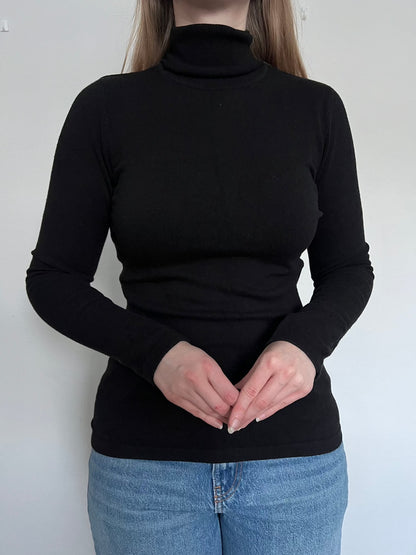 A person wearing the black turtleneck