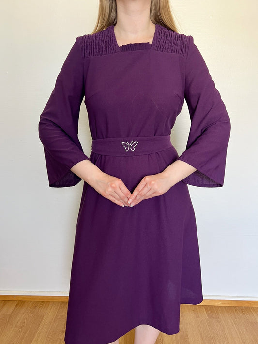 A vintage 60s purple dress with a butterfly detail