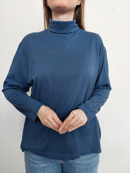 A person wearing the dark blue turtleneck