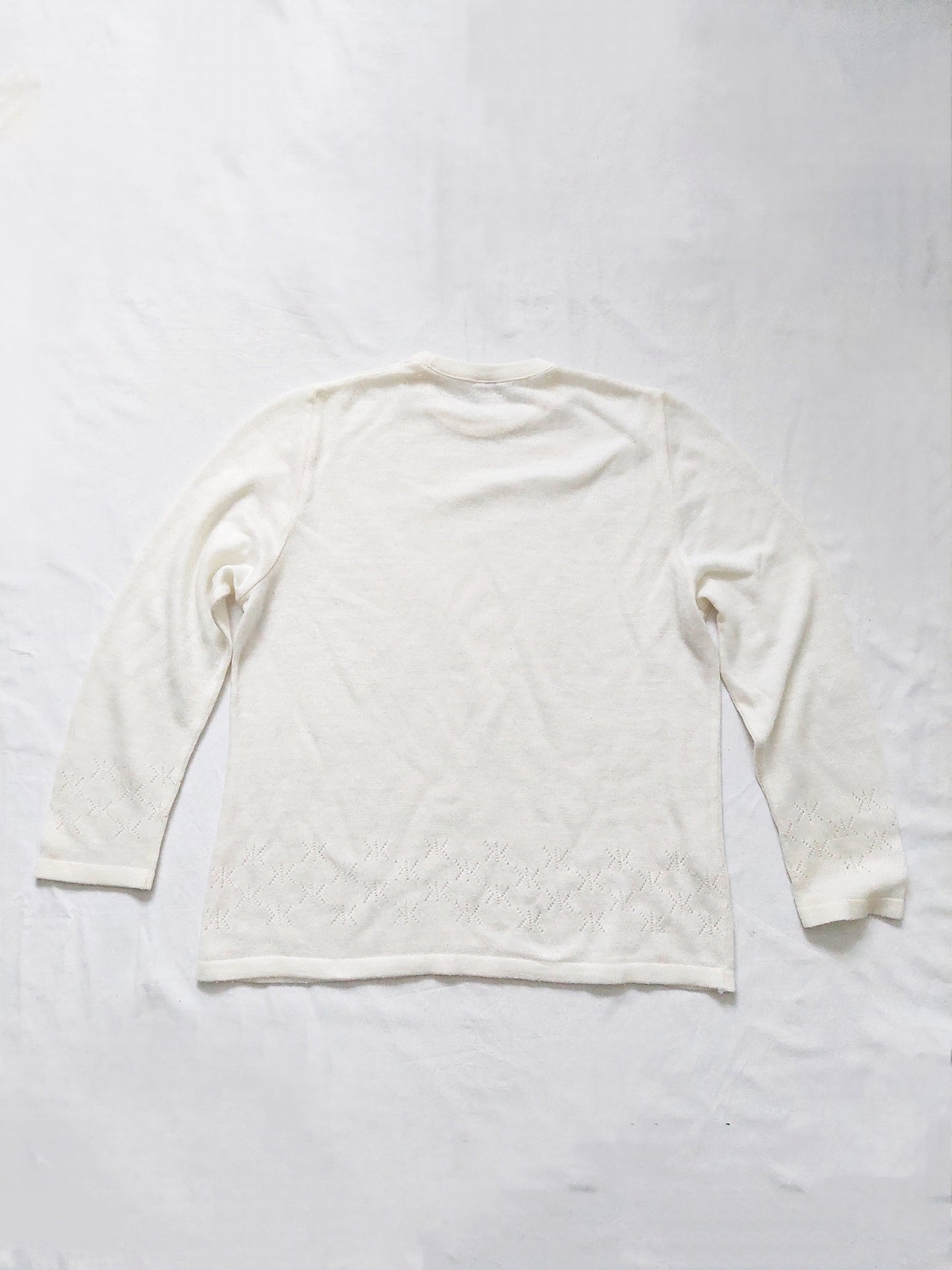 The back of the white sweater