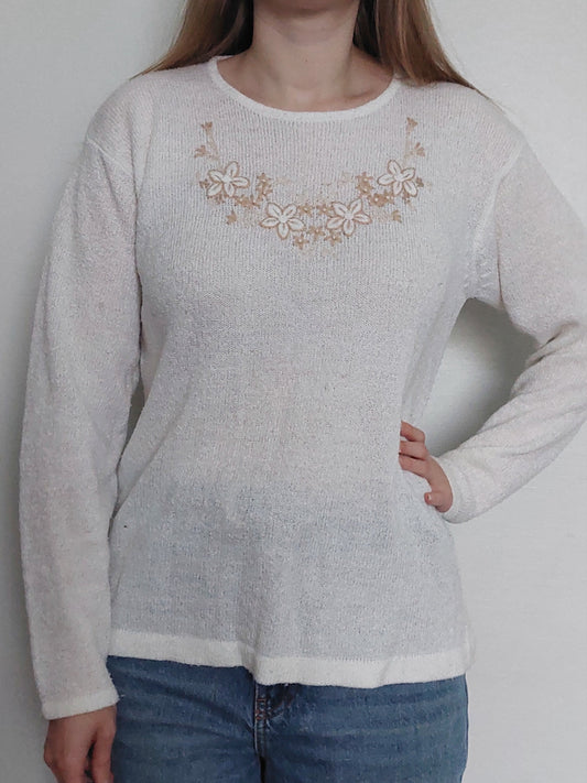 A  person wearing the white flower sweater