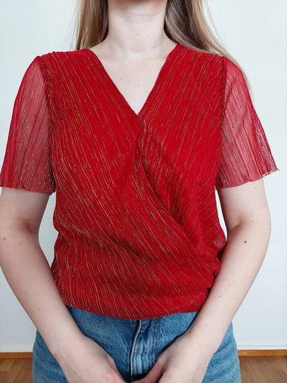 A person wearing the red sparkly t-shirt