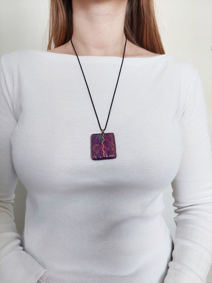 A person wearing the purple stone necklace