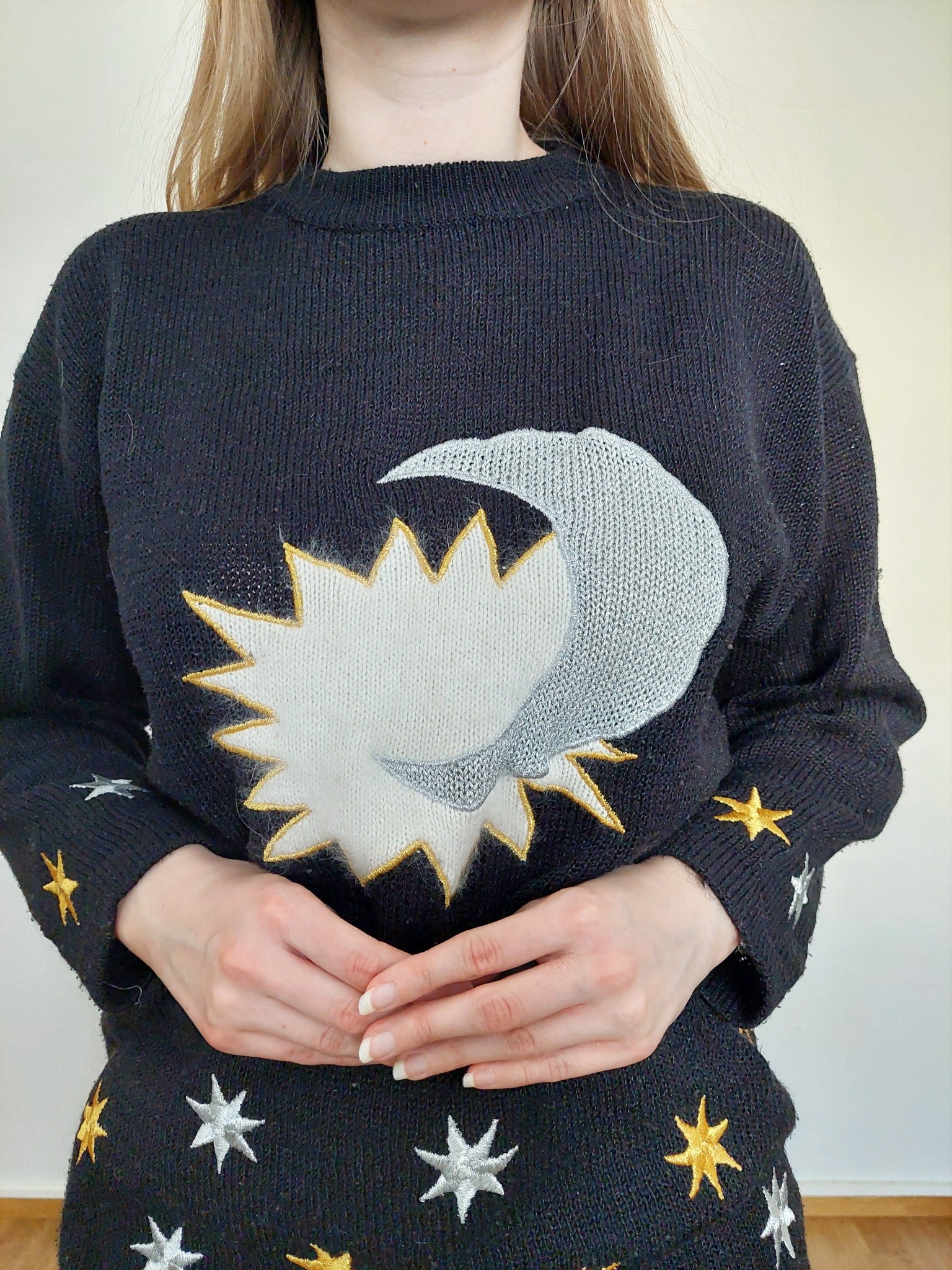 A person wearing the black star sweater