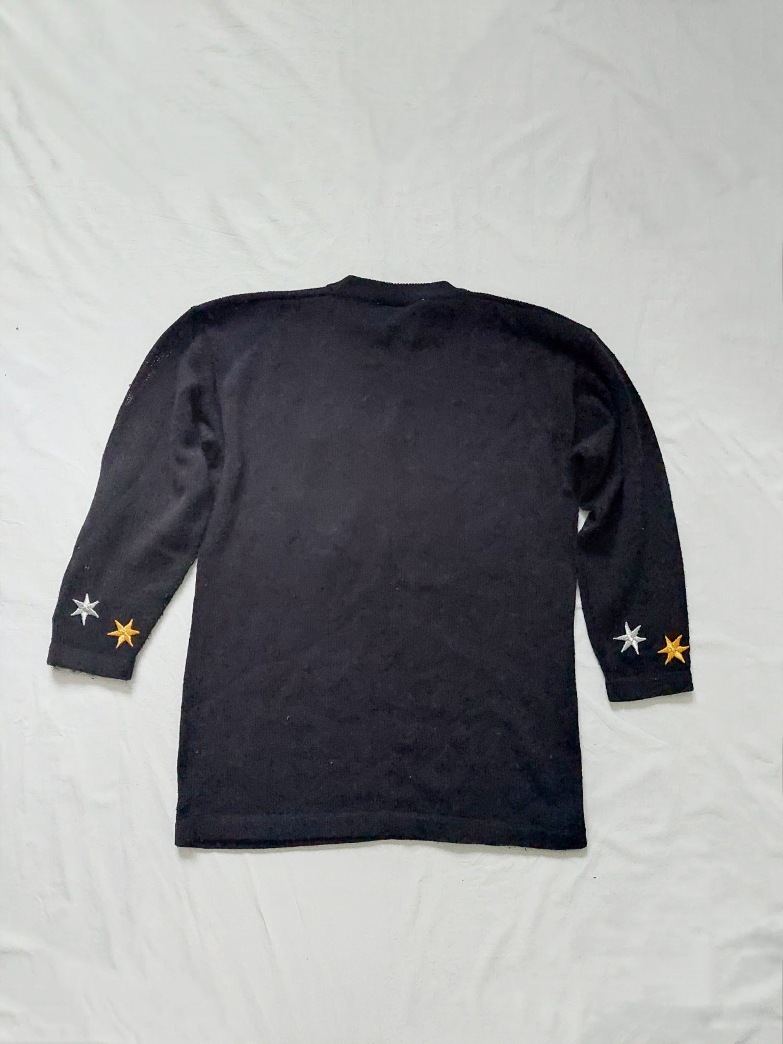 The back of the black star sweater