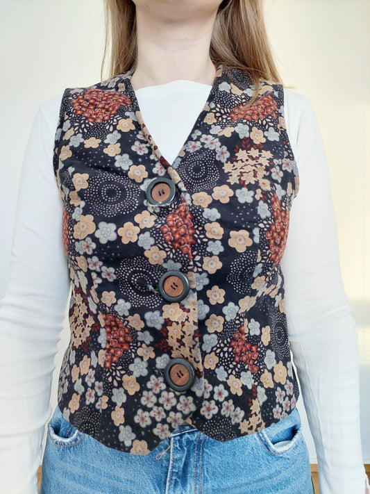 A person wearing the 70s flower vest