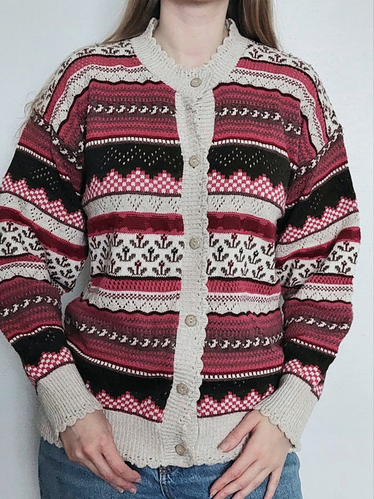 A  person wearing the multicoloured knitted cardigan