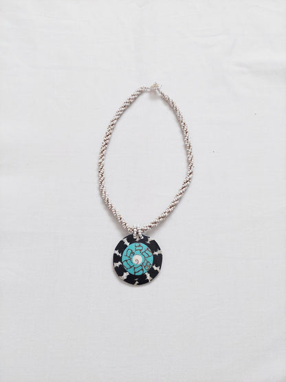 A necklace with a multicolored central piece