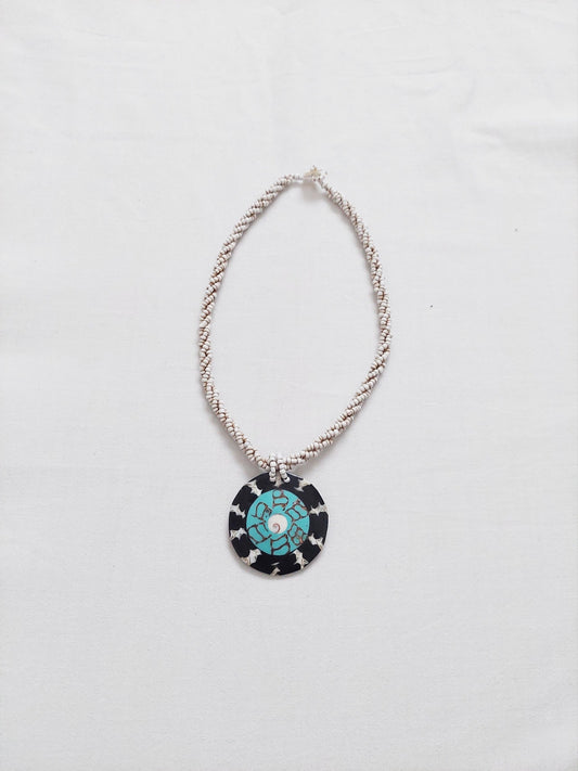 A necklace with a multicolored central piece